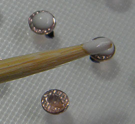 Adding glue to the back of the crystals